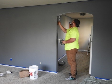Painting, like this guy, is the first thing you do when you remodel your home before moving in